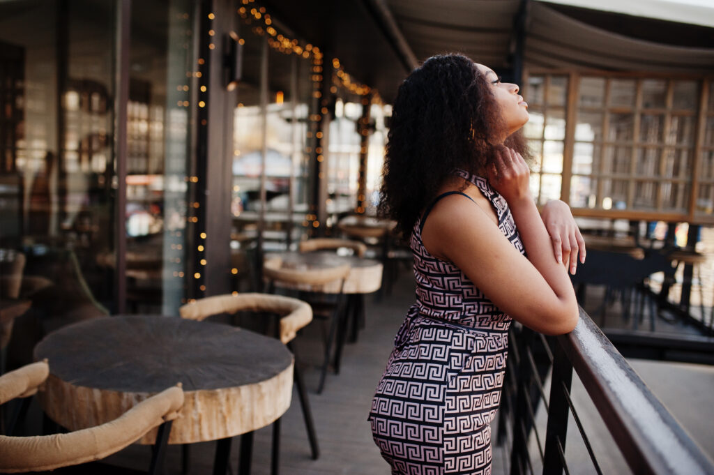 Сharming elegant young african american woman with long curly h